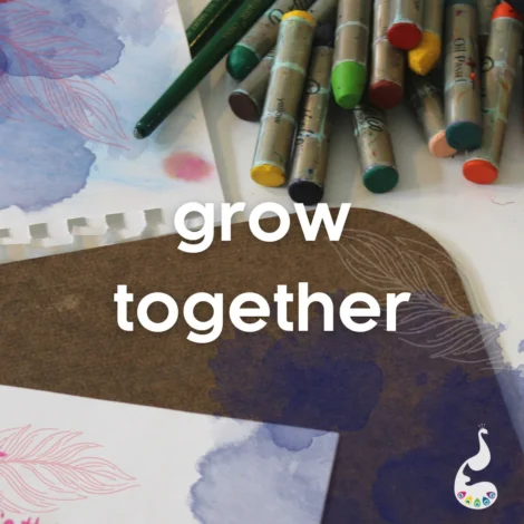 Colored oil pastels, pencils, and sketch paper on a table with "grow together" text and a small peacock logo in the corner.