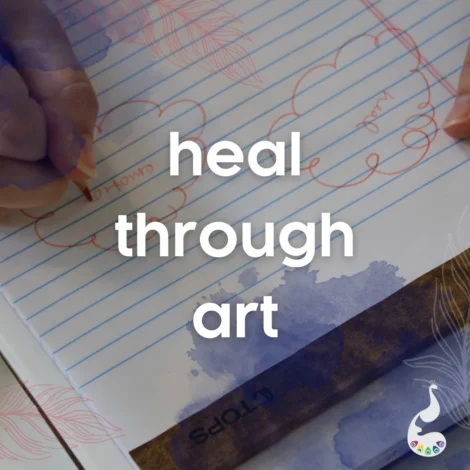 A person writes in a notebook with the words "heal through art" prominently overlaid in white text.